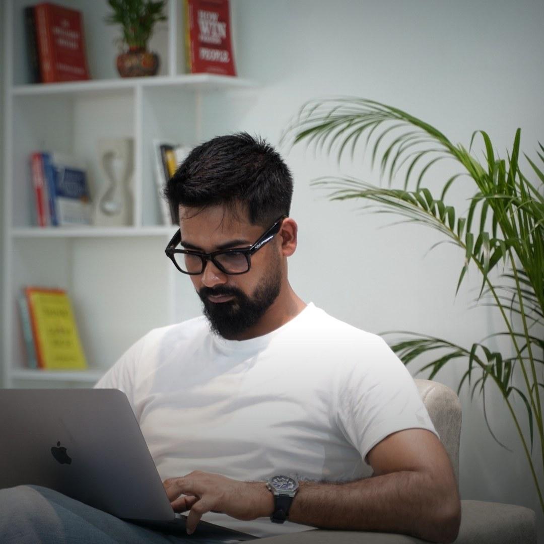 Roni Paul, MedMate founder, working on his laptop in Bengaluru