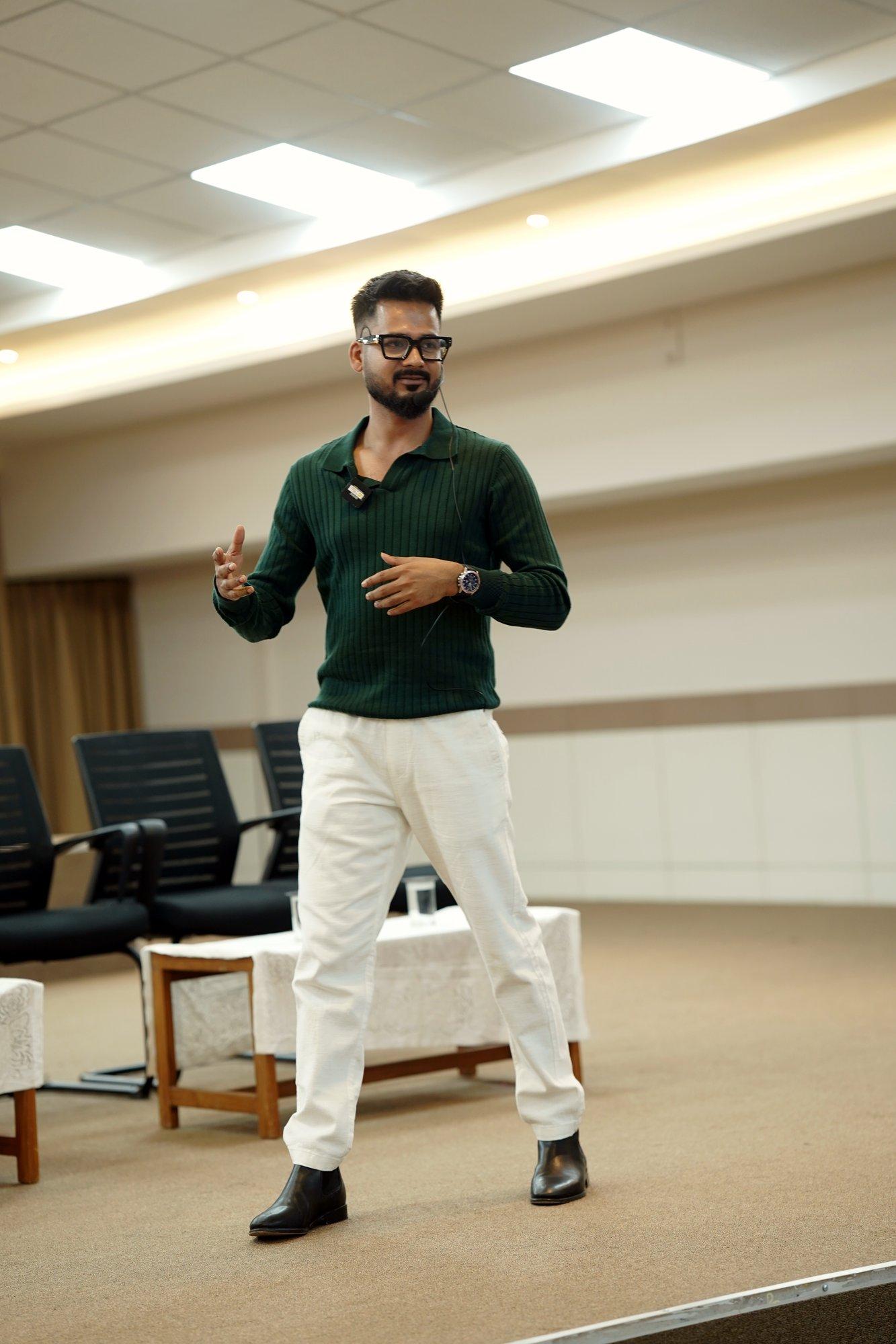 Roni Paul, founder of MedMate, speaking on stage at a college talk in Bengaluru